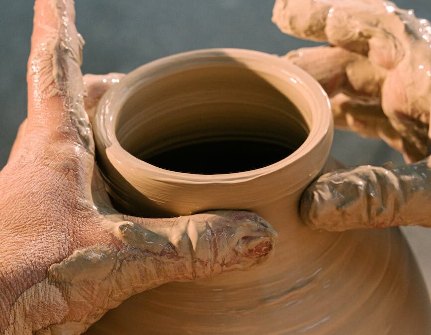 person making clay pot